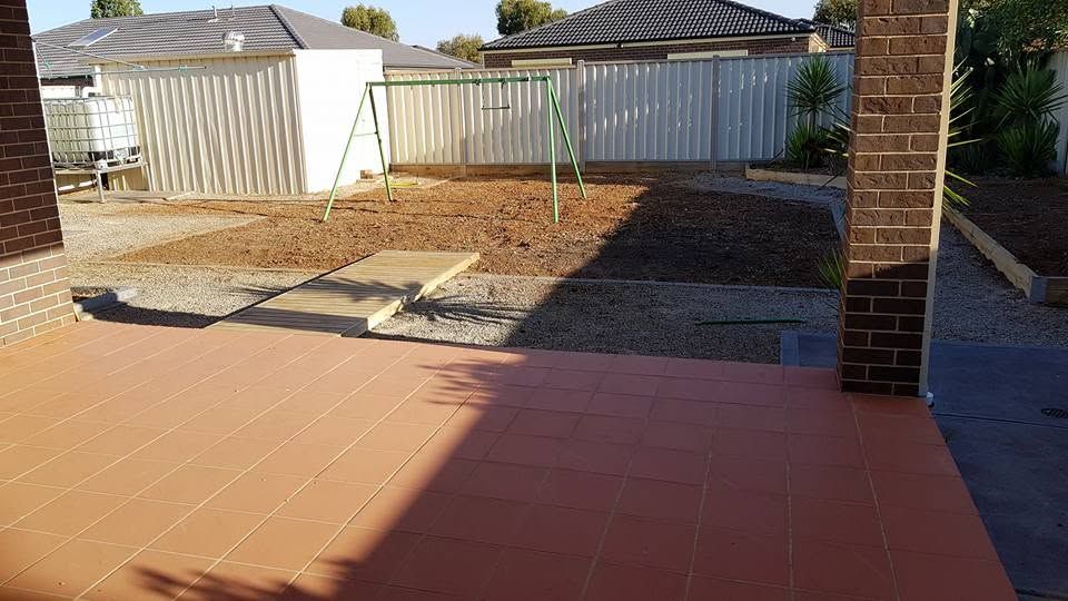 Backyard after clean-up with paving cleared and yard tidy