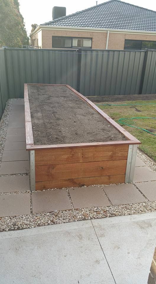 Timber raised garden bed built and filled with soil
