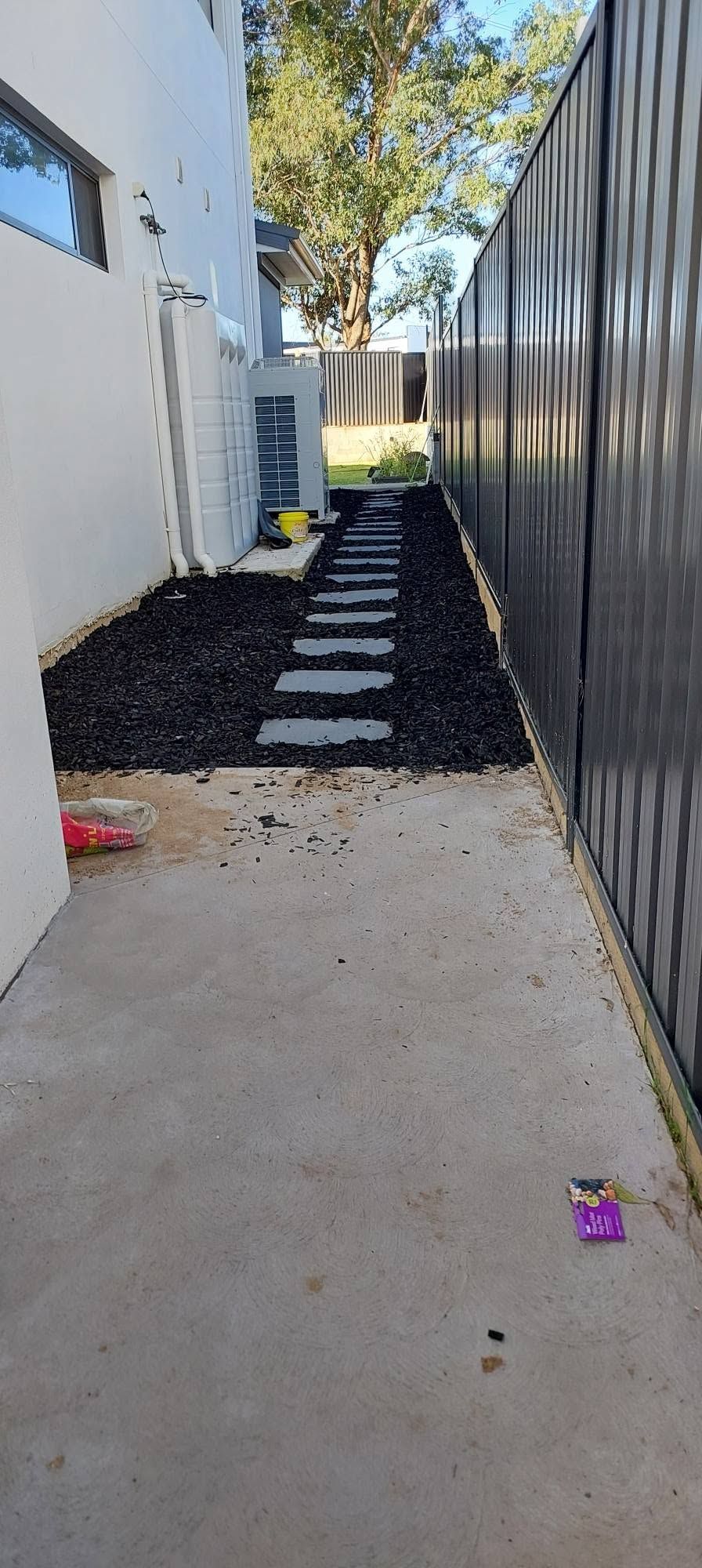 Side access after clean-up with black pebbles and stepping stones